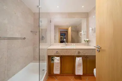 a bathroom with a tub and a sink and a shower at AL - Apartamento Vila Sol F5 AB in Vilamoura
