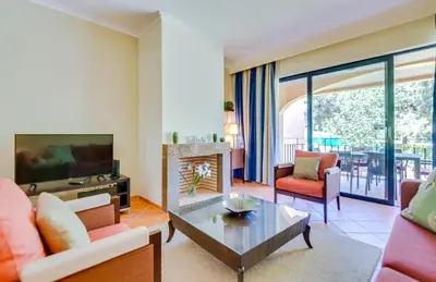 a living room with a couch and a tv at AL - Apartamento Vila Sol F5 AB in Vilamoura