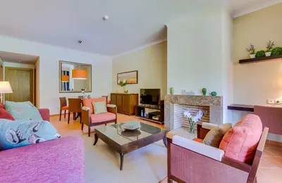 a living room with two couches and a fireplace at AL - Apartamento Vila Sol F5 AB in Vilamoura
