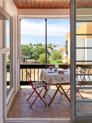 a table and chairs on a balcony with a view at Cosy beach apartment in Albufeira centre in Albufeira
