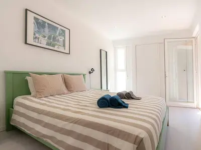 a bedroom with a bed with two towels on it at Cosy beach apartment in Albufeira centre in Albufeira
