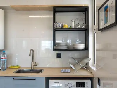 a kitchen with a sink and a counter with dishes at Cosy beach apartment in Albufeira centre in Albufeira
