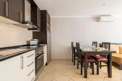 two beds in a small room with a window at ☼ Pé do Lago 1 Bedroom Apartment with Pool in Quarteira