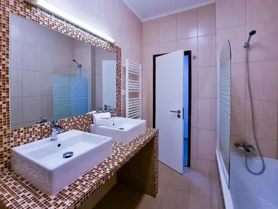 a bathroom with two sinks and a shower and a mirror at Albufeira Old Town T3 with Balcony in Albufeira