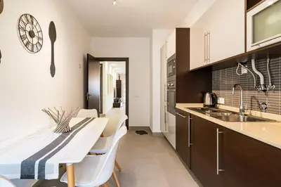 a kitchen with a table and chairs and a sink at ALBUFEIRA (OLD TOWN) VERASOL AA - THE LUXURY STAY in Albufeira