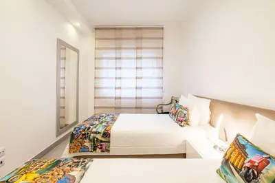 a bedroom with two beds and a window at ALBUFEIRA (OLD TOWN) VERASOL AA - THE LUXURY STAY in Albufeira