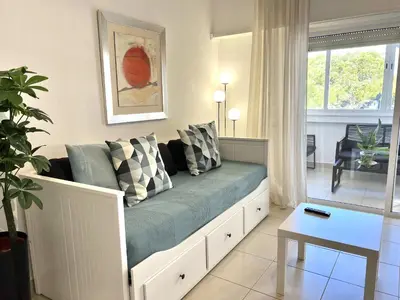 a living room with a couch and a table at Torre 20 - Near the beach - Quarteira in Quarteira