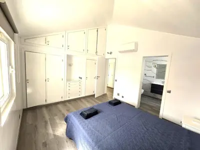 a white bedroom with a blue bed and a window at Villa Sunshine - Albufeira in Albufeira