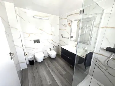 a white bathroom with a sink and a mirror at Villa Sunshine - Albufeira in Albufeira