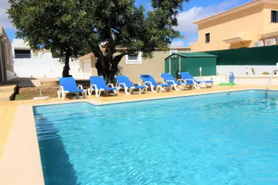 a patio with a table and chairs under awning at Villa Sunshine - Albufeira in Albufeira