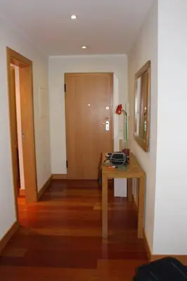 a room with a table with a flower on it at Charming 3-Bed Apartment in Albufeira in Albufeira