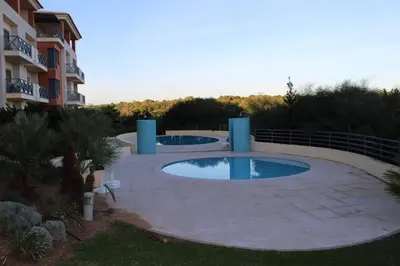 a large swimming pool in a yard next to a building at Charming 3-Bed Apartment in Albufeira in Albufeira