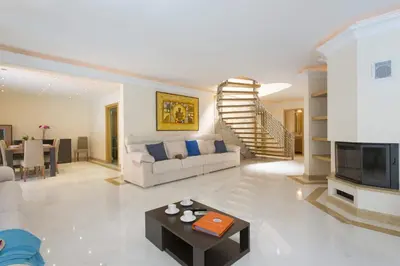 a living room with a couch and a table at Villa Falesia Mar by Villa Plus in Olhos de Água