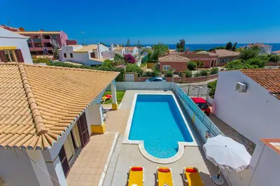 a swimming pool in the backyard of a house at Villa Miraflores by Villa Plus in Albufeira