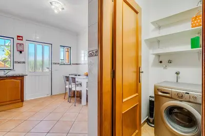 a living room with a couch and a flat screen tv at Villa Rafaela com piscina Albufeira in Albufeira