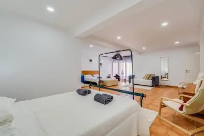 a bedroom with two beds and a mirror at Villa Rafaela com piscina Albufeira in Albufeira