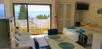 a bedroom with a bed and a room with a balcony at Ocean View - Fantástico Studio em Albufeira in Albufeira