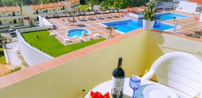a bottle of wine sitting on top of a building at Ocean View - Fantástico Studio em Albufeira in Albufeira