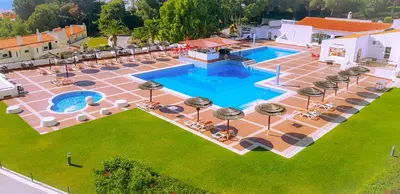 an overhead view of a pool with tables and chairs at Ocean View - Fantástico Studio em Albufeira in Albufeira