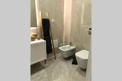 a bathroom with a toilet and a sink at Apartamento Rooftop Montenegro in Faro