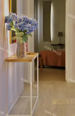a vase of blue flowers sitting on a table at Villa Lilac - walking distance to beach in Albufeira