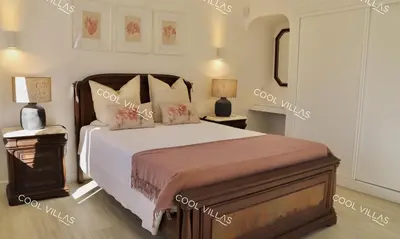 a bedroom with a large bed and two night stands at Villa Lilac - walking distance to beach in Albufeira