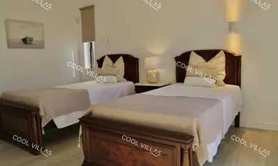 a hotel room with two beds and a mirror at Villa Lilac - walking distance to beach in Albufeira