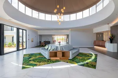 a living room with a couch and a table on a rug at Regency Salgados Hotel & Spa in Albufeira