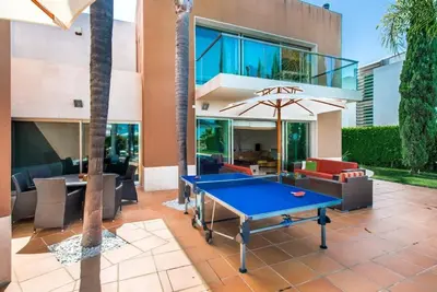 a pool table in front of a building at Villa Laguna, Golf - Stunning house - Laguna Golf Course in Quarteira