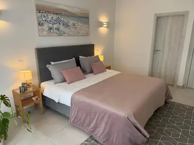 a bedroom with a large bed in a room at Sunny Acacia Apartment in Vale do Lobo