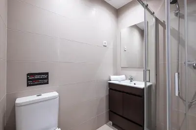 a bathroom with a shower and a toilet and a sink at Atlantic Breeze Apartments by Atlantic Places in Albufeira