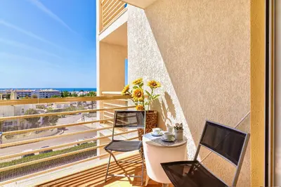 a dining room with a wooden table and chairs at Mar a Vista in Albufeira