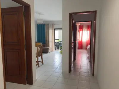a hallway with two open doors and a room at Apartamento Margarita in Quarteira
