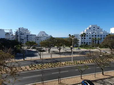 an empty street in a city with tall buildings at Apartamento Margarita in Quarteira