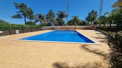 a swimming pool in a yard with a brick patio at Quinta do Pinheiro Premium by Sunny Deluxe in Olhos de Água