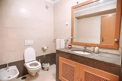 a bathroom with a toilet and a sink and a mirror at Plant Paradise Apartment in Albufeira
