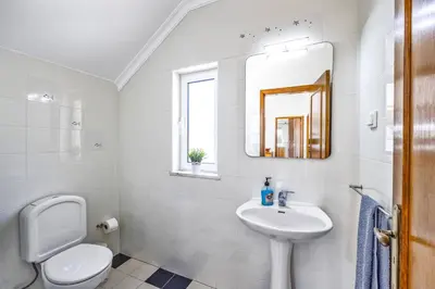 a white bathroom with a sink and a toilet at Villa Anamar by Villa Plus in Albufeira