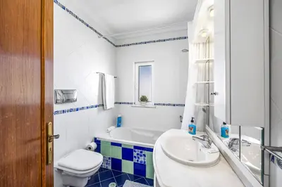 a bathroom with a tub and a toilet and a sink at Villa Anamar by Villa Plus in Albufeira