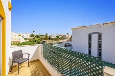 a balcony with a chair and a view at Villa Anamar by Villa Plus in Albufeira