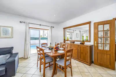 a dining room with a table and chairs at Villa Anamar by Villa Plus in Albufeira