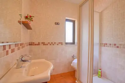 a bathroom with a sink and a toilet at Villa Aveiros by Villa Plus in Albufeira
