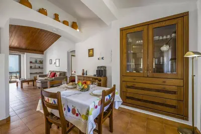 a kitchen and dining room with a table and chairs at Villa Aveiros by Villa Plus in Albufeira
