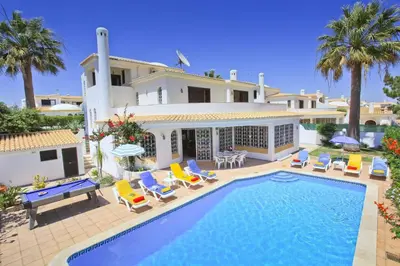 a villa with a swimming pool in front of a house at Villa Elanor by Villa Plus in Albufeira