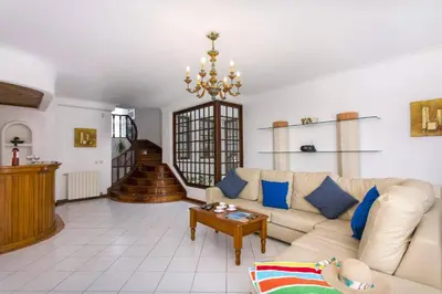 a living room with a couch and a table at Villa Elanor by Villa Plus in Albufeira
