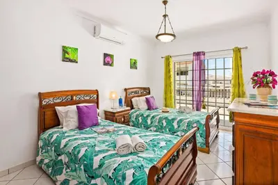 a bedroom with two beds and a balcony at Villa Hope by Villa Plus in Galé