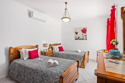 a hotel room with two beds and a table at Villa Hope by Villa Plus in Galé