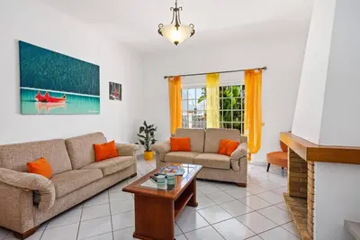 a living room with two couches and a coffee table at Villa Hope by Villa Plus in Galé