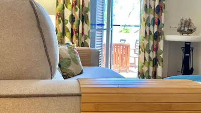 a couch with a pillow on it in a living room at Green and Blue View Apartment in Albufeira