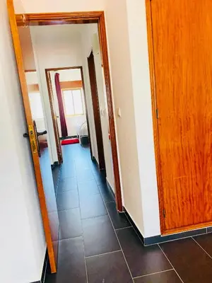a hallway with several doors and a tile floor at Albufeira Beach side Apartment in Albufeira