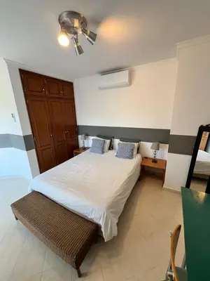 a bedroom with a bed and a ceiling fan at Villa Nox in Brejos